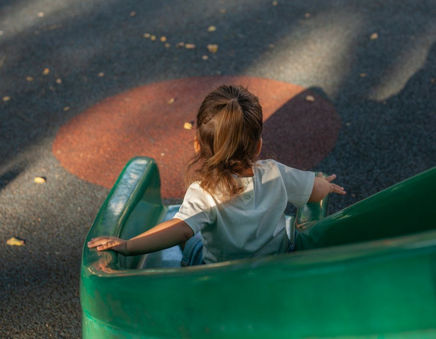 A child going down a slide outdoors