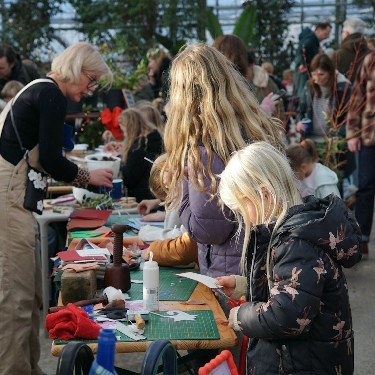 Adults and children making things together at a table