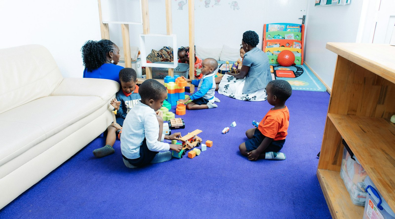 Children playing with toys together in a bright playroom